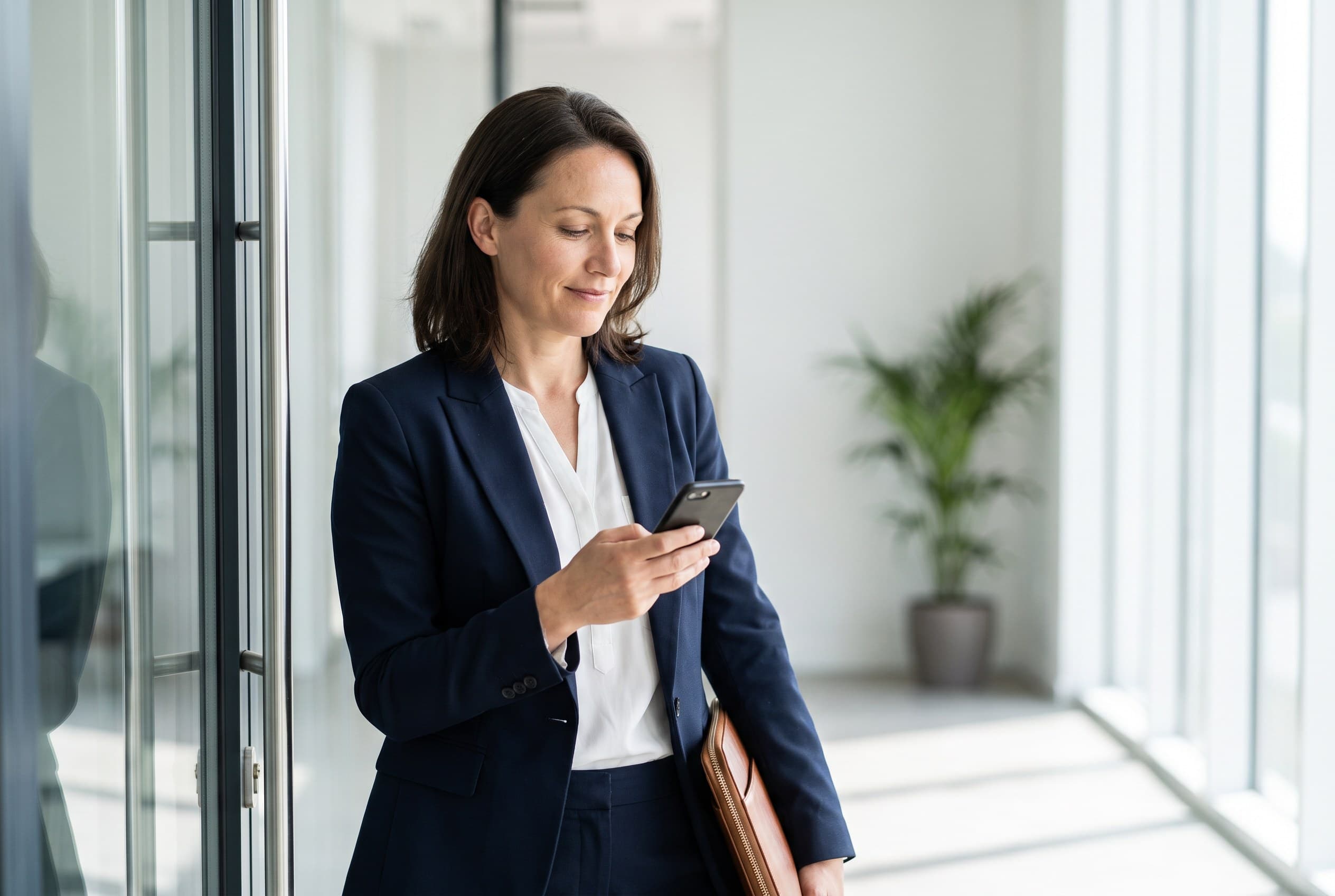 Someone composed and ready, checking a phone or a printed resume before an interview